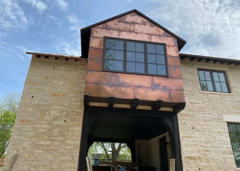 Copper metal panel facade on a stone building for Roof Repair in Kimberly